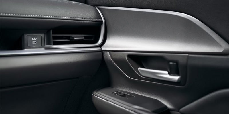 2026 Toyota Grand Highlander interior door panel and handle.