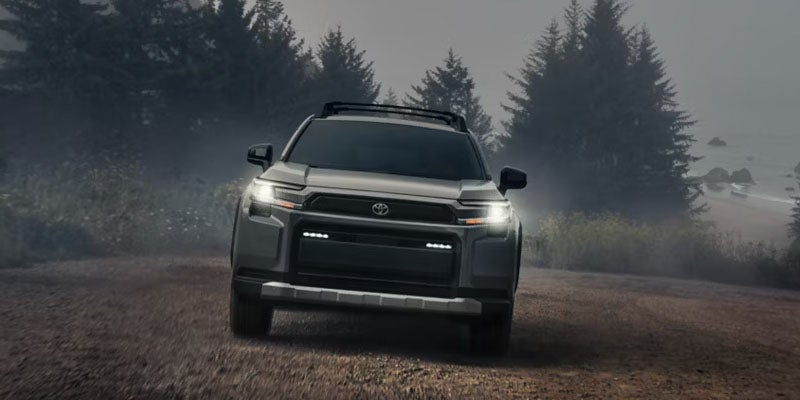 2026 Toyota RAV4 driving on a foggy forest road.
