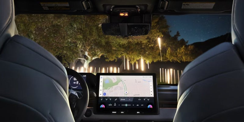 Night view of 2026 BZ Woodland interior showing dashboard and touchscreen navigation display.